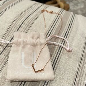Uncommon James Baby V necklace in rose gold. Never worn. In original packaging.